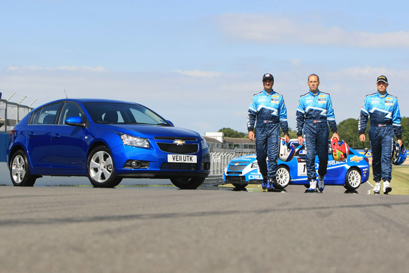 Chevrolet's WTCC race drivers Yvan Muller, Alain Menu and Rob Huff (from left) with the Chevrolet Cruze and Chevrolet Cruze WTCC race car